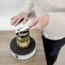 Woman uses the Easy-release lid opener on a glass jar